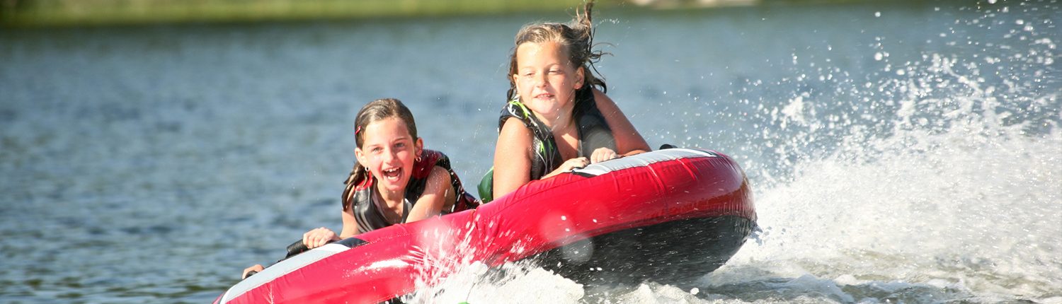 Kids on a tube in a lake